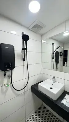 a bathroom with a sink and a mirror at E Hotel Kulim in Kulim