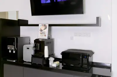 a kitchen counter with two microwaves and a microwave at E Hotel Kulim in Kulim
