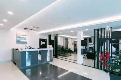 a living room with a blue counter and chairs at E Hotel Kulim in Kulim