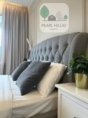 a bed with two pillows on it in a room at Tanjung Bungah PEARL HILL42 Homestay in Tanjung Bungah