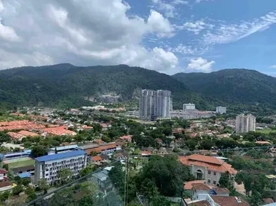 a city with buildings and mountains in the background at Tanjung Bungah PEARL HILL42 Homestay in Tanjung Bungah