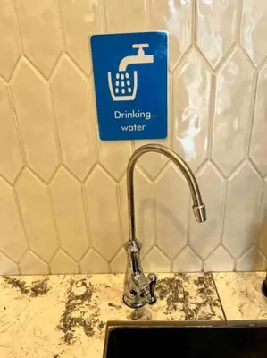 a sink with a drinking water sign on a wall at Tanjung Bungah PEARL HILL42 Homestay in Tanjung Bungah