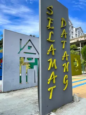a sign for a building with yellow letters on it at Fazlia Resthouse at Golden Hills Cameron Highlands near pasar malam in Tanah Rata