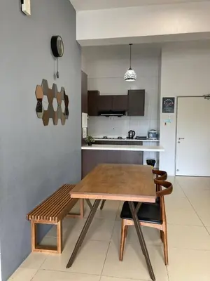 a kitchen with a wooden table and chairs in a room at Fazlia Resthouse at Golden Hills Cameron Highlands near pasar malam in Tanah Rata