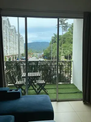 a view of a balcony with a table and chairs at Fazlia Resthouse at Golden Hills Cameron Highlands near pasar malam in Tanah Rata