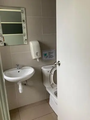 a bathroom with a sink and a toilet and a mirror at Fazlia Resthouse at Golden Hills Cameron Highlands near pasar malam in Tanah Rata
