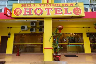 a yellow building with a sign for a hotel at Hill Times Inn Hotel in Ipoh
