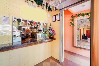 a restaurant with a counter and a window at Hill Times Inn Hotel in Ipoh