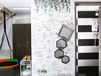 a wall with drawings on it with a laptop on it at Private Tree House - Cinema at CEO Bayan Lepas Penang in Bayan Lepas