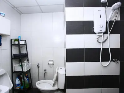 a bathroom with a black and white tiled wall at Private Tree House - Cinema at CEO Bayan Lepas Penang in Bayan Lepas