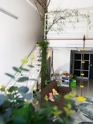a living room with a staircase and a couch at Private Tree House - Cinema at CEO Bayan Lepas Penang in Bayan Lepas