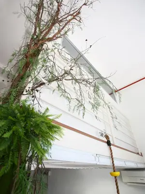 a tree on the side of a house with a rope at Private Tree House - Cinema at CEO Bayan Lepas Penang in Bayan Lepas