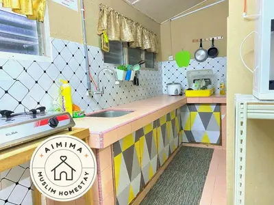 a toy kitchen with a counter and a sink at Aimima Muslim Homestay @ Lost World Of Tambun. in Kampong Batu Lapan