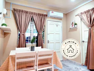 a dining room with a table and a window at Aimima Muslim Homestay @ Lost World Of Tambun. in Kampong Batu Lapan