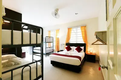 a bedroom with a bed and a bunk bed at Golden Lodge in Tanah Rata