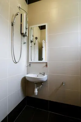a bathroom with a sink and a mirror at Golden Lodge in Tanah Rata