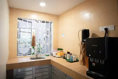 a kitchen counter with a sink and a window at Golden Lodge in Tanah Rata