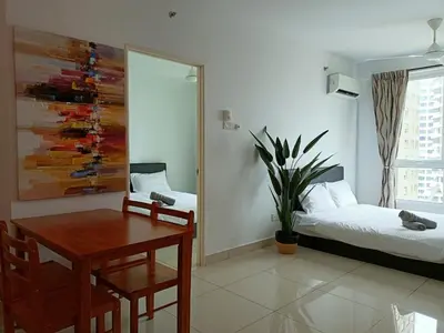 a living room with a table and a bed and a desk at Family Suites at Mansion One by MAJ in George Town
