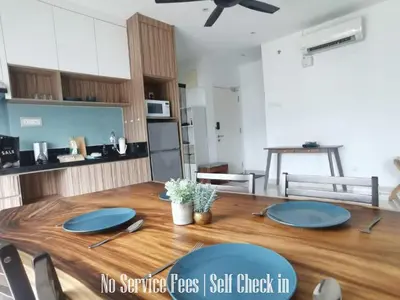 a kitchen with a wooden table with blue plates on it at Family Suites at Mansion One by MAJ in George Town