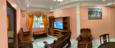 a living room with a tv and some chairs at Holiday Homestay Cameron Highlands in Tanah Rata