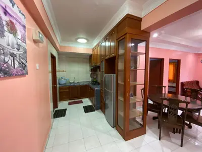 a kitchen and dining room with pink walls and a table at Holiday Homestay Cameron Highlands in Tanah Rata