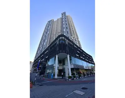 a tall building in front of a street at \u7687\u5bb6\u6d77\u666fROYAL Luxury Seaview Room, 3 minute to Gurney in Tanjong Tokong
