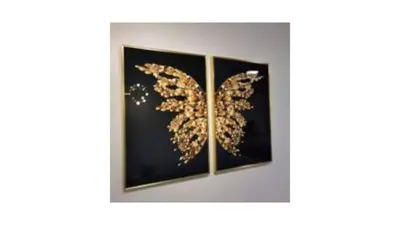 two framed paintings of a gold butterfly on a black wall at Tree Family Executive Suite 3 BR /8 PAX Gurney in Tanjong Tokong