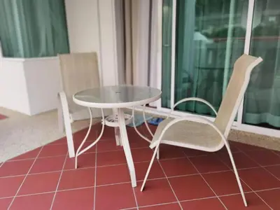 a table and two chairs sitting next to a glass table and chairs at WOW Strait Quay Luxury Suite Room in Tanjong Tokong
