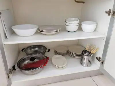 a white shelf with bowls and plates and utensils at SUMMERSET 8PAX 3BR LUXURY SEAVIEW SUITE ROOM in George Town