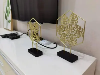 two gold sculptures on a white counter with a television at SUMMERSET 8PAX 3BR LUXURY SEAVIEW SUITE ROOM in George Town