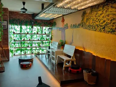 a room with a table and chairs and a wall at Sekinchan PaddyCruise Homestay Wifi in Sekincan