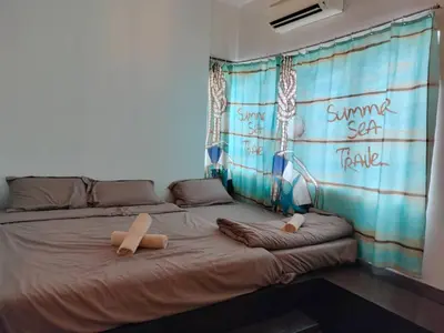a bed with two pillows on it in a room at Sekinchan PaddyCruise Homestay Wifi in Sekincan