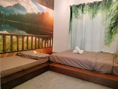 two beds in a room with a mural on the wall at Sekinchan PaddyCruise Homestay Wifi in Sekincan
