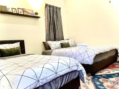 a bedroom with two beds and a window at Zarahome in Tambun