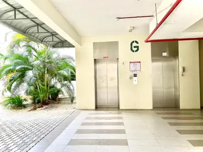 an empty lobby of a building with two elevators at Zarahome in Tambun