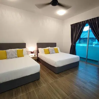 a bedroom with two beds and a window at W39WarmStay@GoldenHills/NightMarket/4R/BBQ in Brinchang
