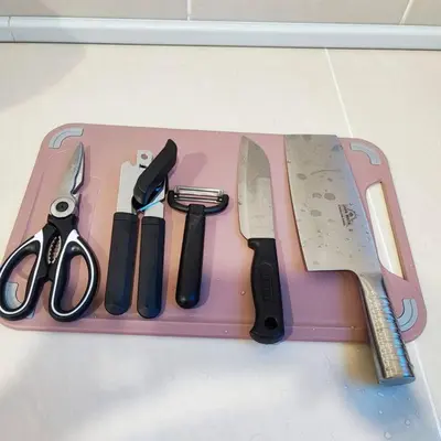 a pink cutting board with a knife and other kitchen utensils at W39WarmStay@GoldenHills/NightMarket/4R/BBQ in Brinchang