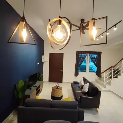 a living room with two couches and a tv at W39WarmStay@GoldenHills/NightMarket/4R/BBQ in Brinchang