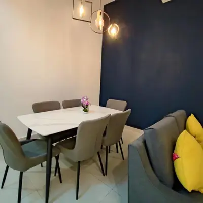 a dining room with a table and chairs and a couch at W39WarmStay@GoldenHills/NightMarket/4R/BBQ in Brinchang
