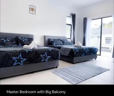 two beds in a bedroom with big balcony at New 2 storey-Majestic Homestay 3 min to Night Market in Brinchang