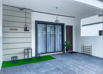a living room with a plant in the corner of a building at New 2 storey-Majestic Homestay 3 min to Night Market in Brinchang