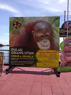 a sign with a monkey on it on a sidewalk at Yussal Homestay in Simpang Ampat Semanggol
