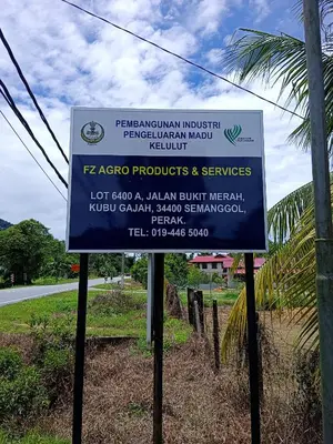 a sign on the side of a road at Yussal Homestay in Simpang Ampat Semanggol