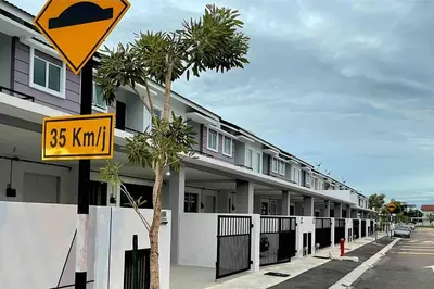 a yellow street sign next to a building at Hanan Homestay Klebang Ipoh with a view of Mount Korbu, for Musl!m only!! in Ipoh