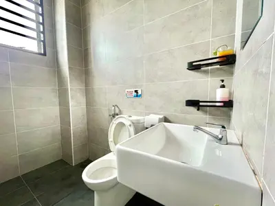 a bathroom with a white toilet and a sink at Hanan Homestay Klebang Ipoh with a view of Mount Korbu, for Musl!m only!! in Ipoh