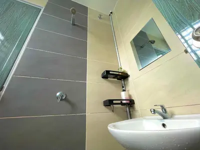 a bathroom with a sink and a mirror at Hanan Homestay Klebang Ipoh with a view of Mount Korbu, for Musl!m only!! in Ipoh