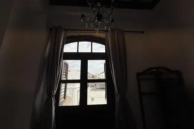 a window in a room with a chandelier at Carnarvon Heritage Lodge in George Town