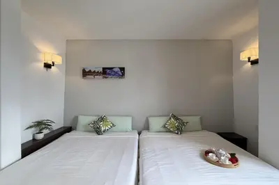 a bedroom with two beds with a bowl on it at Carnarvon Heritage Lodge in George Town