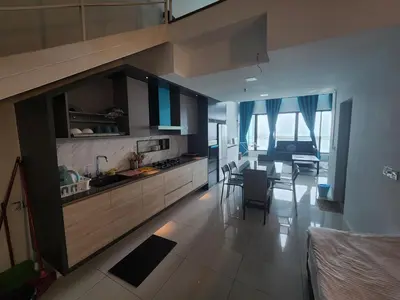 a living room with a kitchen and a dining room at Sunrise Gurney Premium Suite - Gurney Drive in George Town