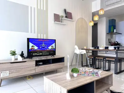 a living room with a tv and a table with chairs at Georgetown#Beacon Executive Suite SkyPool#Luxury&Glamorous Suite#2BR#Living Room with Queen Bed in George Town